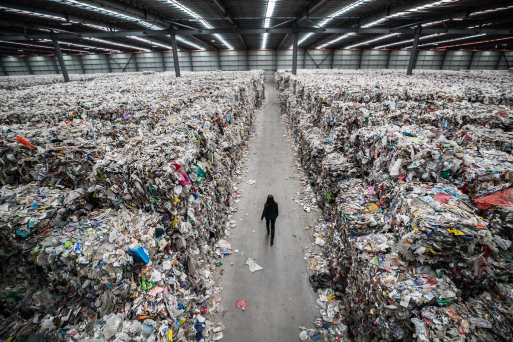 Image of Person Walking Through Plastic Waste