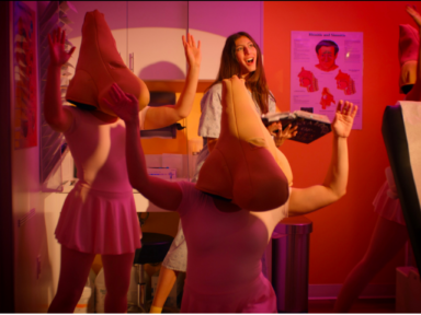 Image of Catalogue of Noses writer Lauren Schaffel dancing with "nose characters" in screen shot from film