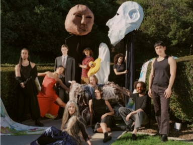 group of people with oversized puppets